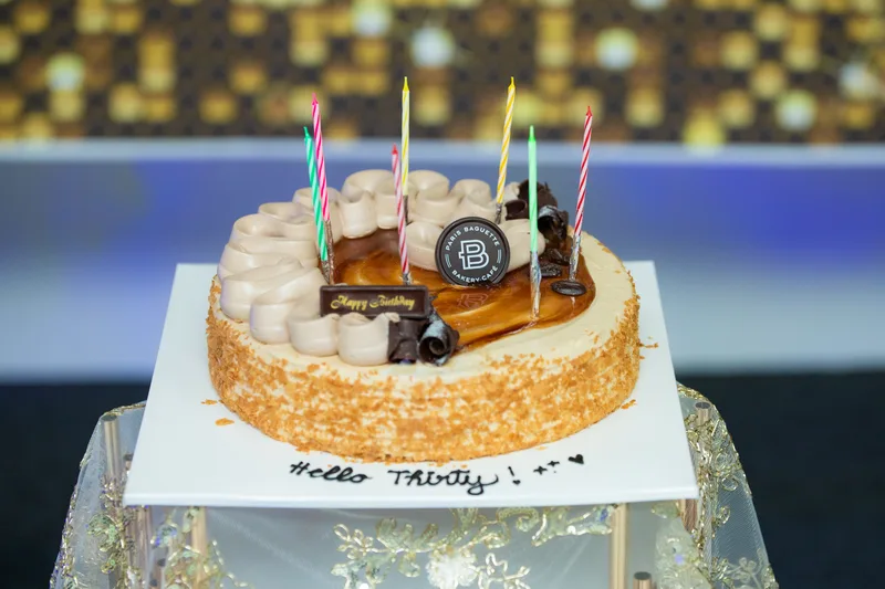 Birthday cake with gold sequin backdrop at MP Venue
