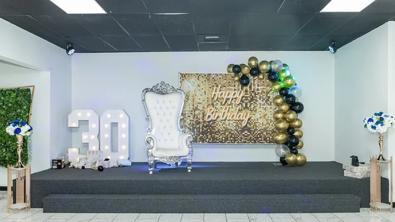 Ballroom stage with gold backdrop and silver throne chair