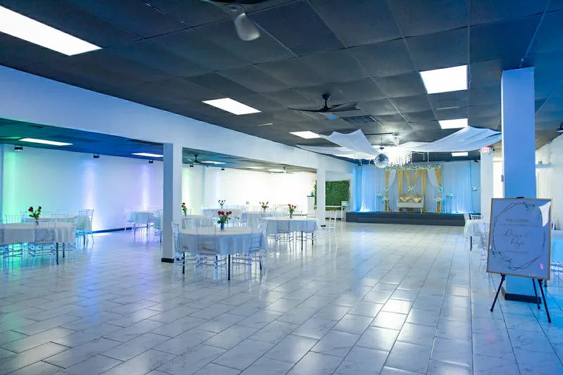 Ballroom with blue uplighting showing full venue layout at MP Venue DFW