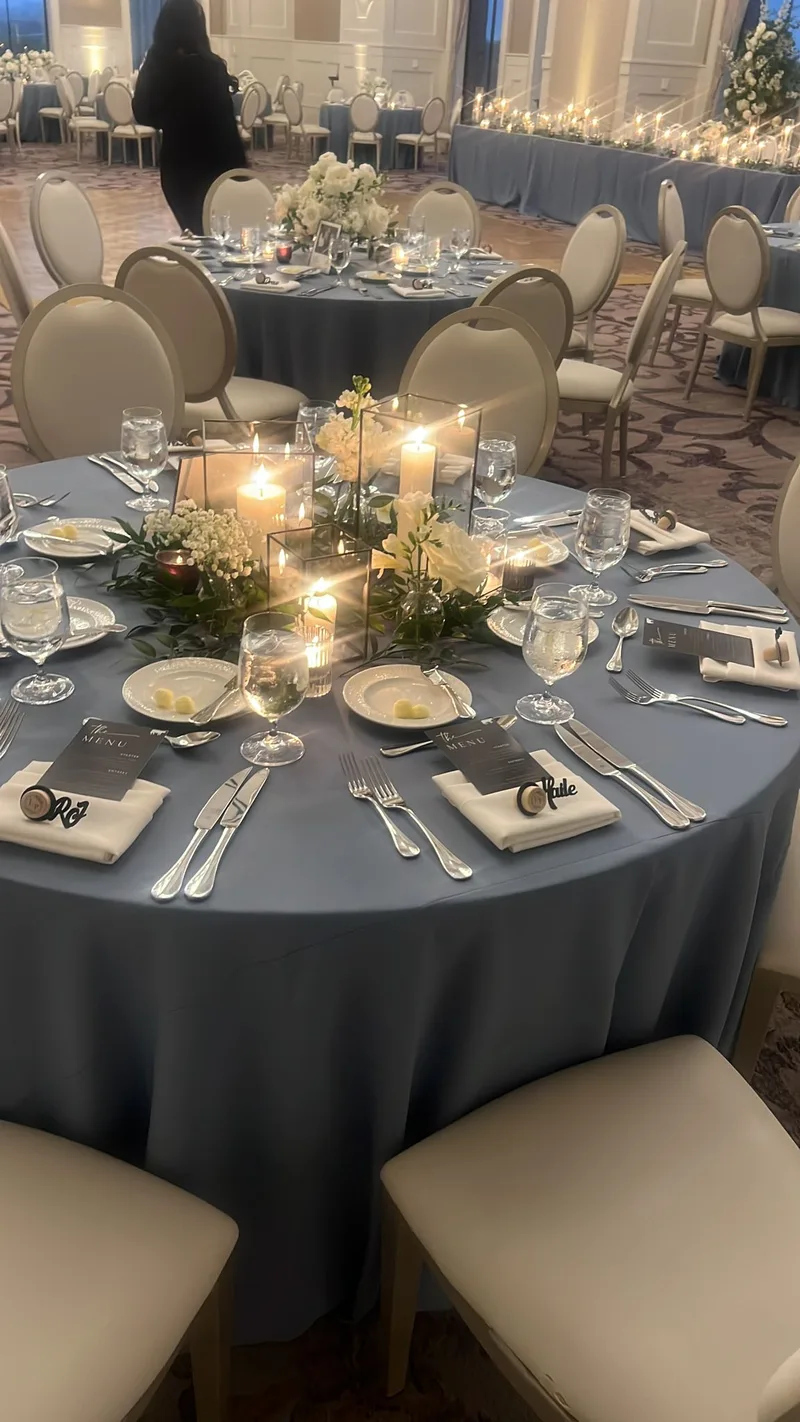Gray linen table with warm candle centerpiece at a wedding reception