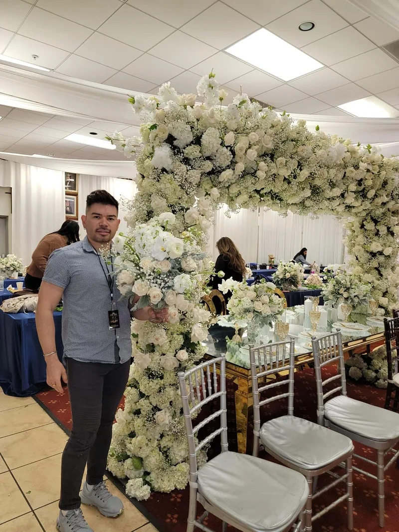 White floral arch with mirrored table and chiavari chairs